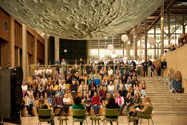 AP Moon - People sat in an auditorium at an event